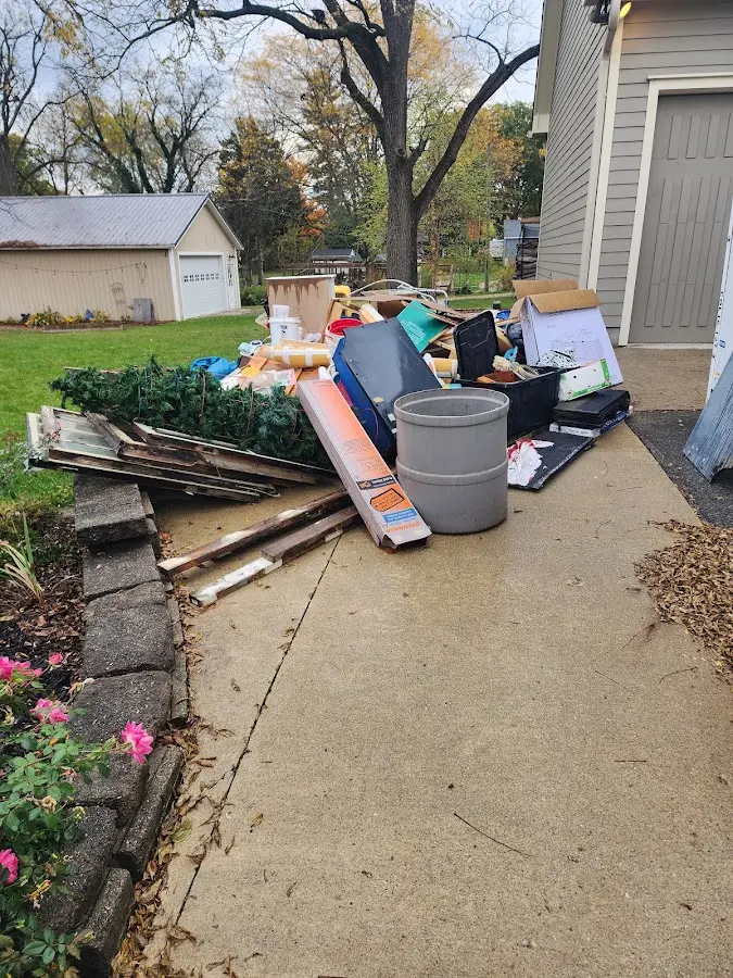 Dumpster being loaded with debris for Estate Cleanout Dumpster Rental in Eufaula
